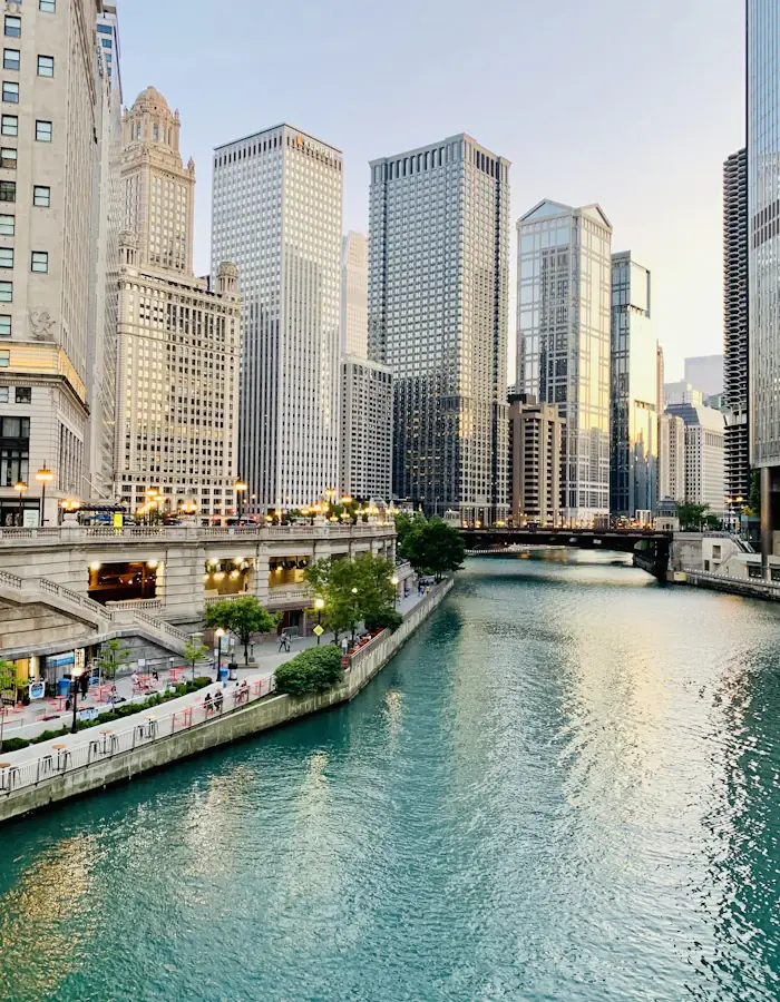 Couple walking the Chicago Riverwalk below the bridges on a warm evening