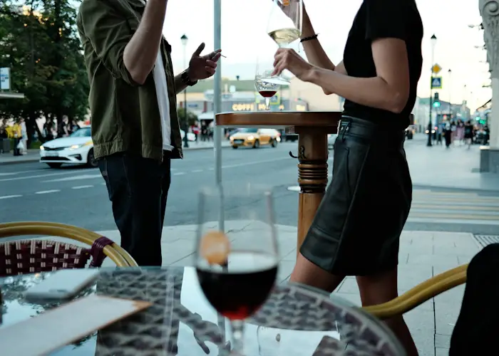 Two glasses of wine on a small table in a warmly lit Chicago bar